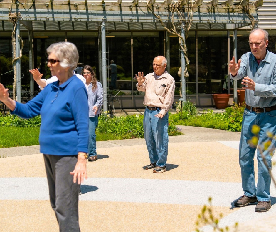  Seniors practicing tai chi in the Levy Center courtyard