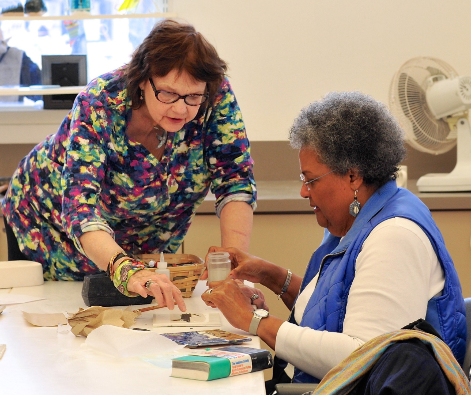 A lady and art instructor working on an art project