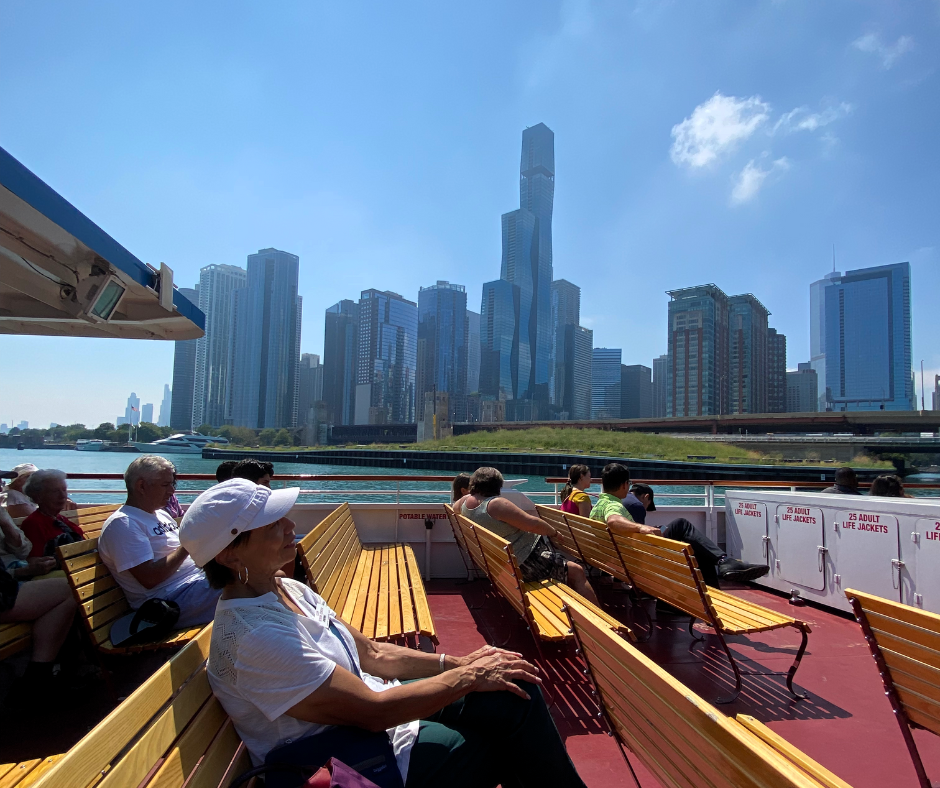 A Levy Center member on a boat enjoying the Chicago skyline